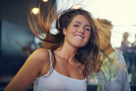 Young woman dancing to the music at a concert. This concert was created for the sole purpose of this photo shoot, featuring 300 models and 3 live bands. All people in this shoot are model released.の写真素材