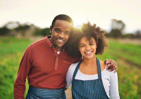 Our farm is thriving. Cropped portrait of an affectionate young couple standing on their farm.の写真素材