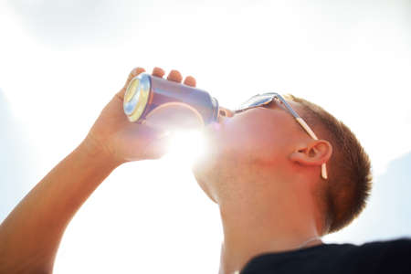 Nothing refreshes better than a cold beer. Closeup of a young man wearing sunglasses drinking a beer...