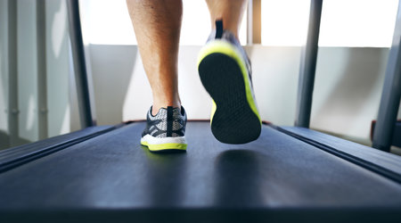 The long walk to fitness. Cropped shot of an unrecognizable man jogging on a treadmill in the gym.