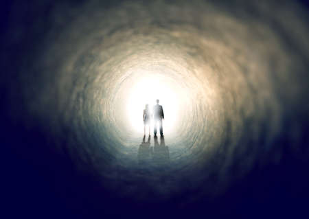 Finding the light. A shot of two people finding an exit from a dark tunnel - ALL design on this image is created from scratch by Yuri Arcurs team of professionals for this particular photo shoot.の写真素材