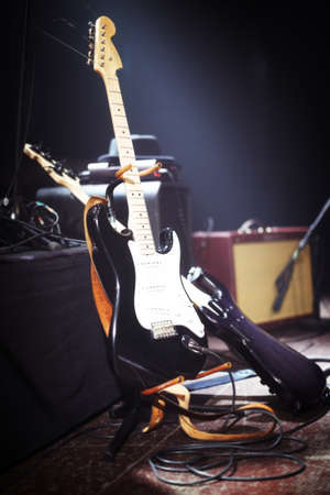 Behind the scenes at a gig. Electric guitars set up on a stage.の写真素材