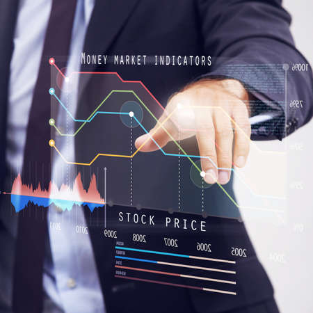 Rising stocks. Cropped studio shot of a businessman using a digital interface to review stocks.