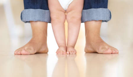 Guiding steps. Cropped image of a baby learning to walk.の写真素材
