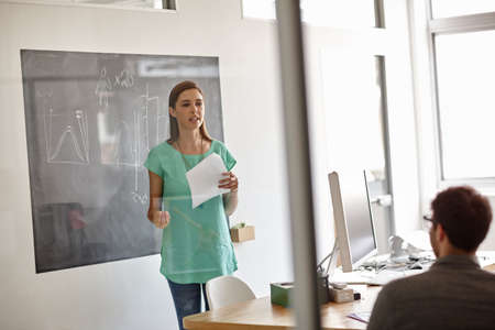 Smart advice from innovative businesspeople. Shot of a young designer presenting her business...