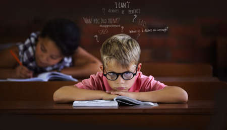 Confused and struggling to learn - Learning disabilities. Young boy feeling overcome with boredom in...