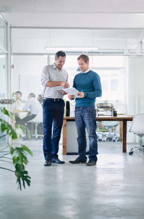 Fantastic stuff. Shot of two colleagues having a discussion in the office.