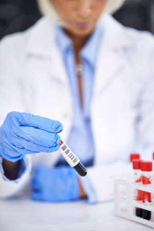 Pathology at work. Cropped shot of a scientist working with blood samples in her lab.