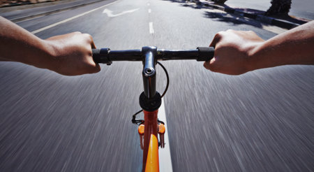 Living life behind bars. POV shot of a person riding a bicycle along a road.の写真素材