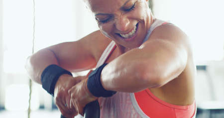 Know what 100 looks like and give it. Shot of a young woman working out with a kettle bell in a gym.