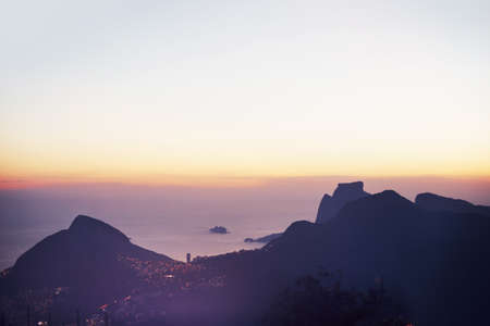 The city comes alive at night. View of a city and its coastline.の写真素材
