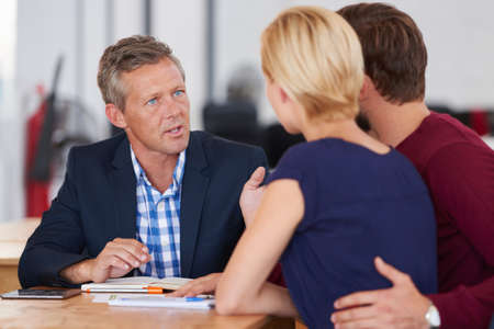 Learning about great asset management. Young couple discussing investment plans with a financial...