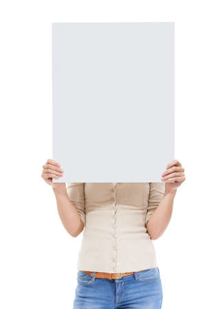 Getting behind your idea. Studio shot of a woman holding a blank sign in front of her face isolated on white.の写真素材