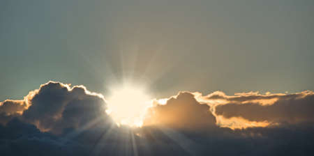 Bright sunshine through dark clouds. Sunshine breaking through dark clouds on the horizon.