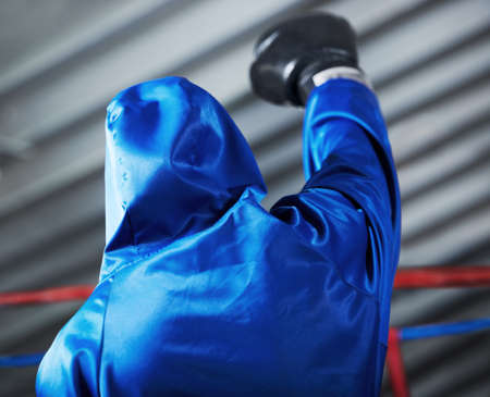 Motivation. Rear view of a boxer with his fist in the air.の写真素材