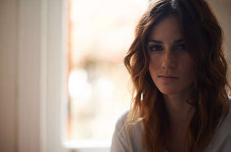 Just being herself. Cropped portrait of a casual young brunette at home.