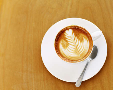Made by an skilled barista. High angle shot of an artistically prepared cup of cappuccino sitting on...
