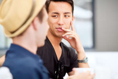 Talking to your best friend is sometimes all the therapy you need. Shot of a young man listening to...
