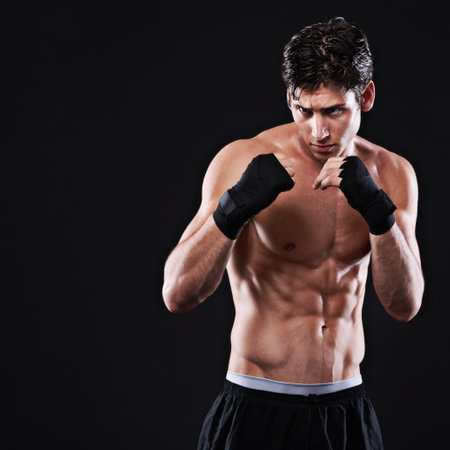The perfect fighting stance. Studio shot of a young mixed martial artist.の写真素材