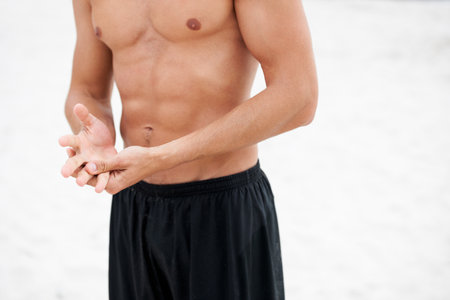 Chiselled chest and abdominals. Cropped image of an attractive man standing shirtless showing his abdominal muscles.の写真素材