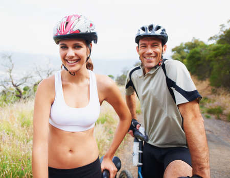 Biking buddies. Portrait of a healthy sporting couple going for a bike ride together.の写真素材