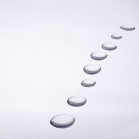Water drop trail. Trail of water droplets on clear surface.の写真素材
