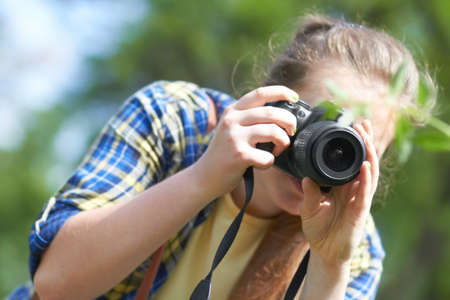 Practicing her photography. A gorgeous young woman taking a picture with her camera.
