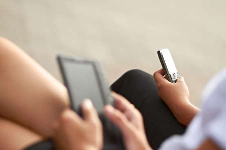Modern technology. Cropped image of two students, one with a digital tablet and one with a...