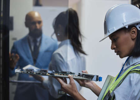 The wonder of getting up close and personal. Shot of a young woman closely inspecting a motherboard...