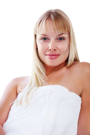 Smiling blond woman wrapped in a towel against white. Cute blond female wrapped in a bath towel against white background.の写真素材