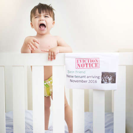Dont I get a say. Shot of an unhappy baby boy crying while standing in his crib.の写真素材