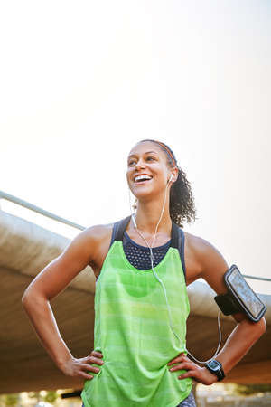 Great day for a great run. Shot of a sporty young woman exercising outdoors.の写真素材