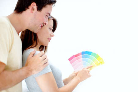 What colour would you pick - Copyspace. Over the shoulder image of a young couple picking a colour for their bedroom - Copyspace.の写真素材