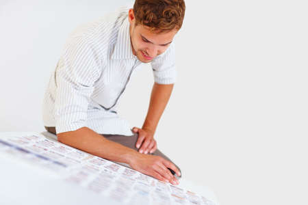 Male photographer sitting on table. Male photographer sitting on table and looking at his photos.