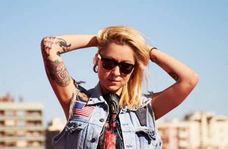 Capture my style. Shot of a young woman with tattoos.の写真素材