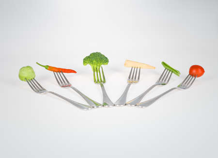 Mouthful of goodness. A series of forks with healthy mouthfuls of vegetables on them.の写真素材