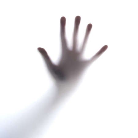 Trying to get out. Cropped shot of an unrecognizable persons hand against a seethrough film.