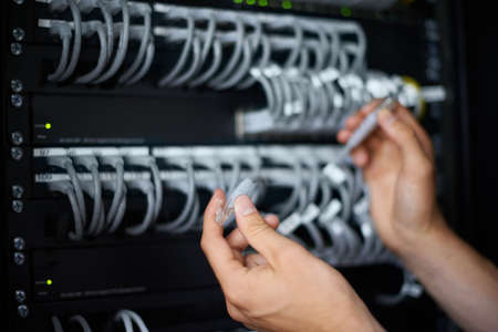 Ready to get you back online. A computer technician connecting cables.