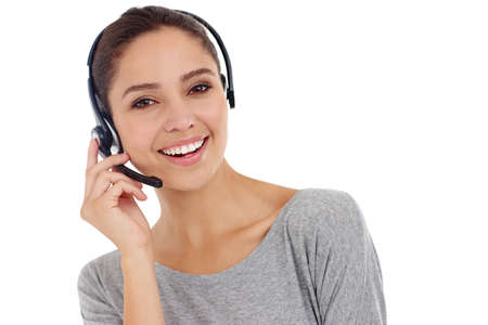 Friendly support with a smile. Studio shot of a young woman wearing a hands-free headset.