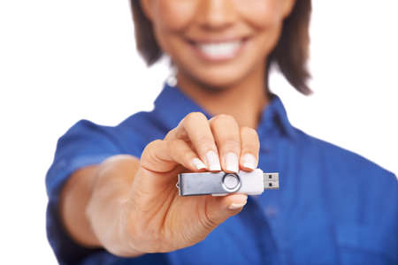 Plenty of space on this one. An african-american woman showing you a USB stick.の写真素材