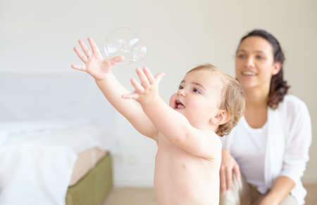 What wonders the world has in store for her. An adorable baby girl reaching for a bubble with her...