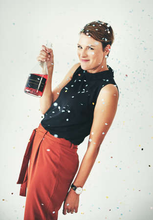 I brought my own drink to the party. Shot of an attractive young woman drinking a bottle of...