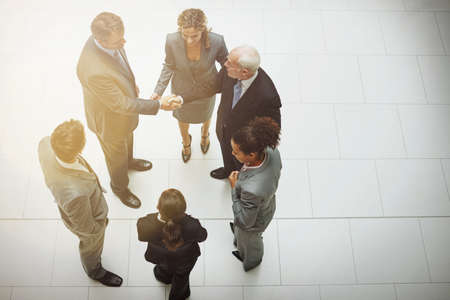 Were gonna do great things together. High angle shot of two groups of business teams meeting for the first time.の写真素材