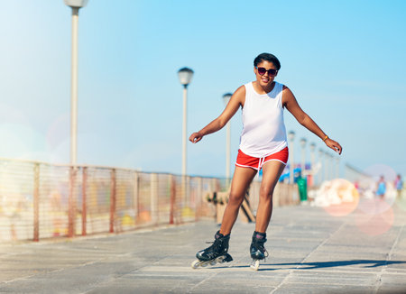 Im all about worrying less and rollerblading more. Shot of an attractive young woman rollerblading...