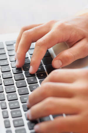 Got his fingers on the pulse of business. Cropped shot of a businessmans hands on a laptop keyboard.
