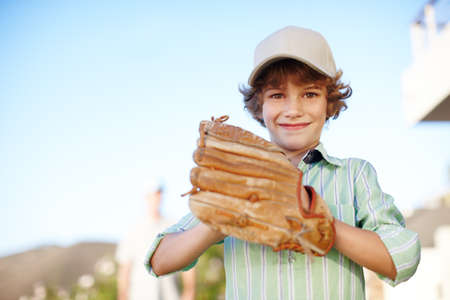You ready. Cropped portrait of a young boy playing baseball in the yard with his father in the...