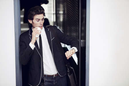 Is that the time. A young man realising hes late.