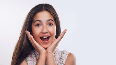 I like surprises. Cropped portrait of an attractive teenage girl standing alone against a white...