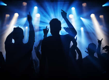 Fun at the gig. Silhouette of a crowd of young adults at a concert.の写真素材