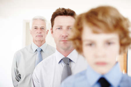 Standing in the middle of three generations. Cropped portrait of a handsome man standing with his...